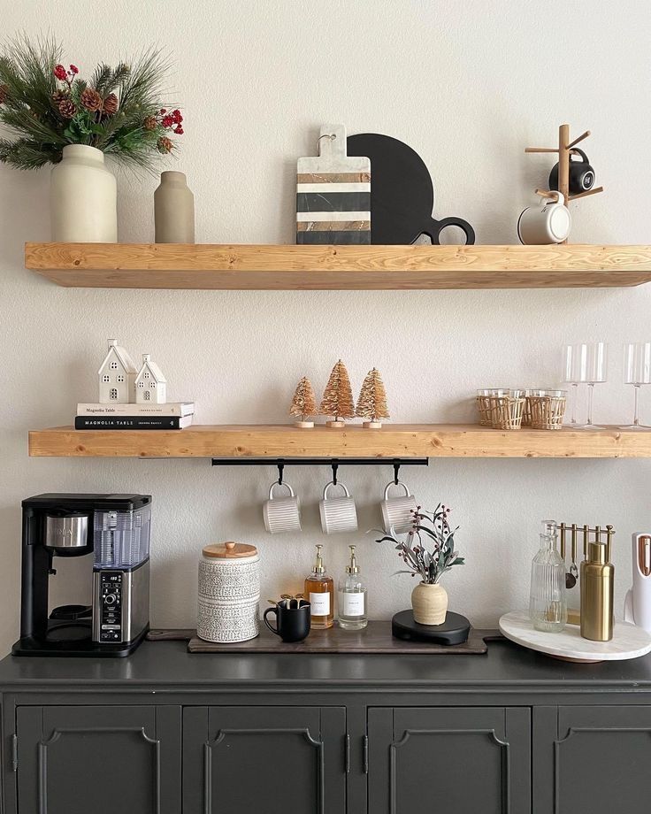 two wooden shelves above a coffee bar with cups and mugs on it