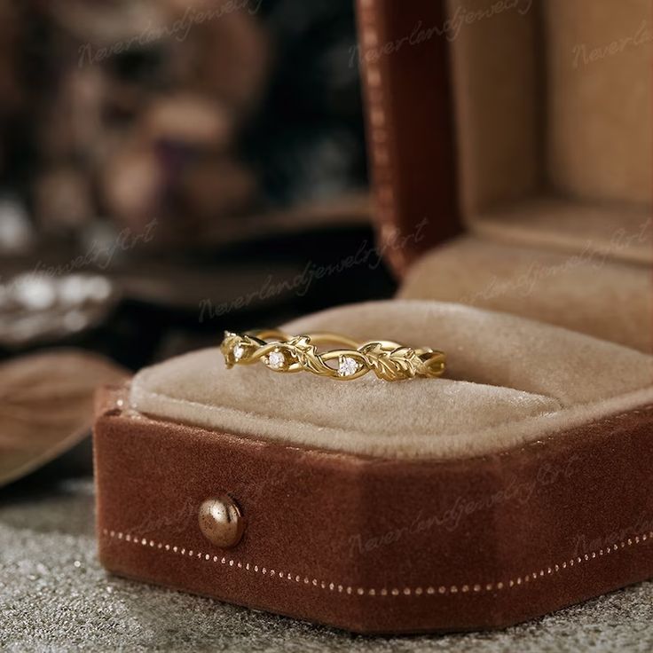 an open box with a gold ring in it