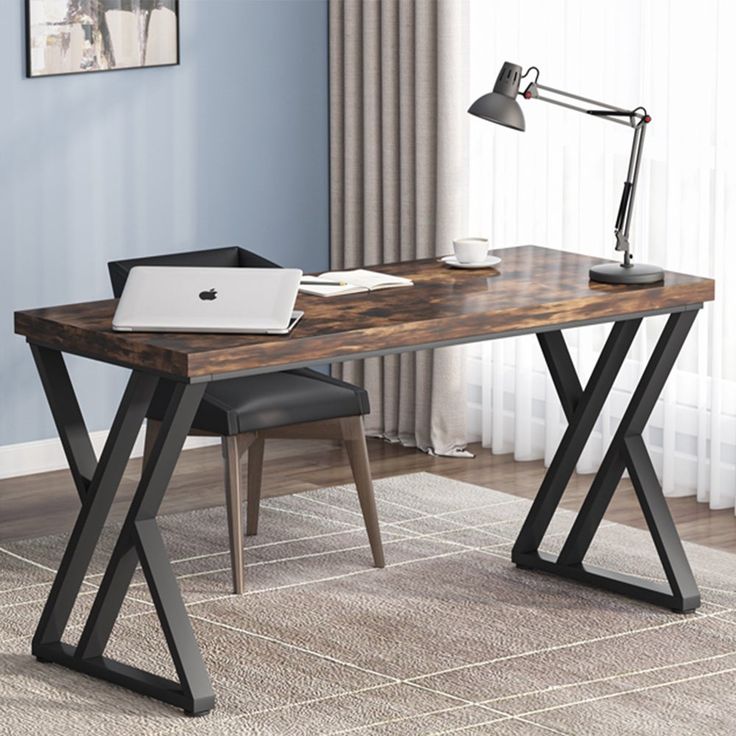 a computer desk with a laptop on it and a chair next to it in front of a window