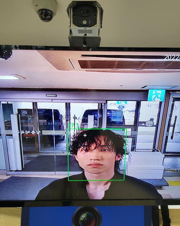 a man is shown on the television screen with his face in front of him,