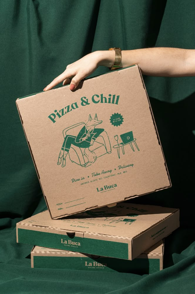 two pizza boxes stacked on top of each other with one being held up by a woman's hand