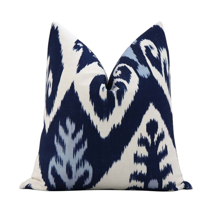 a blue and white pillow on a white background