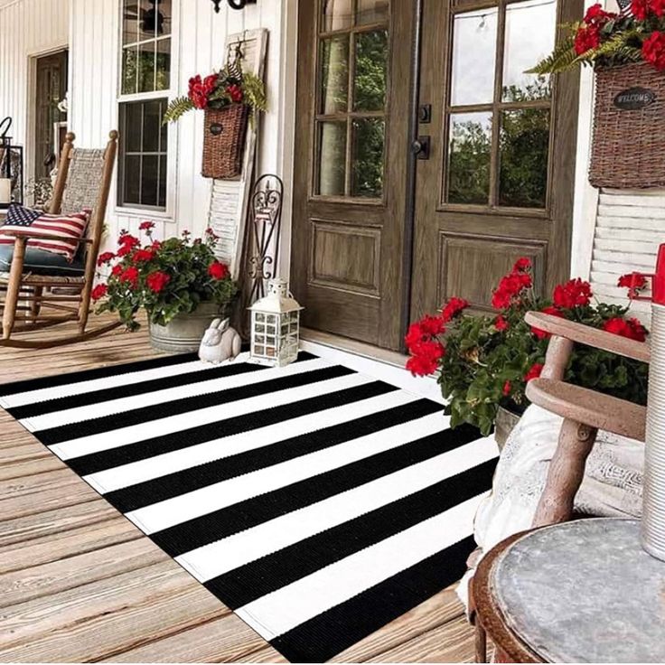 the front porch is decorated with red and white flowers