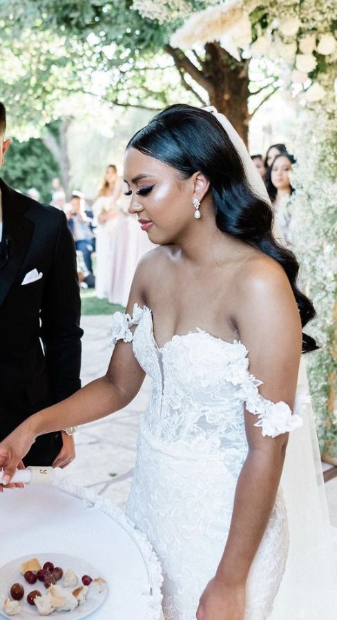 a bride and groom cutting their wedding cake