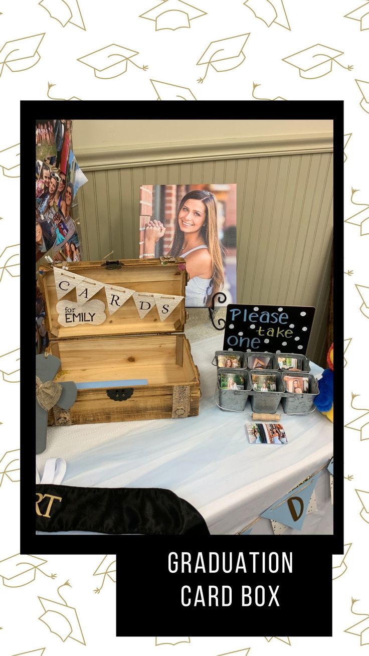 a graduation card box sitting on top of a table next to other cards and photos