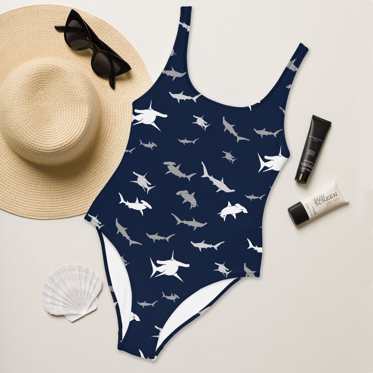 Show your love for sharks by donning our unique one-piece swimsuit. Enjoy the smooth fabric and the flattering design, and show it off by the beach, pool or on your next SCUBA excursion. * 82% Polyester, 18% Spandex * Chlorine-resistant fabric * Cheeky fit with a scoop neckline and a low scoop back * Zig-zag stitching * Double-layer front * Four-way stretch material stretches and recovers on the cross and lengthwise grains At TheOffShore, we specialise in creating unique, vibrant, colourful and Shark Swimsuit, Shark Gifts, Swim Suit, Scuba Diving, Women Swimsuits, Scoop Neckline, Bathing Suit, One Piece Swimsuit, Bathing Suits