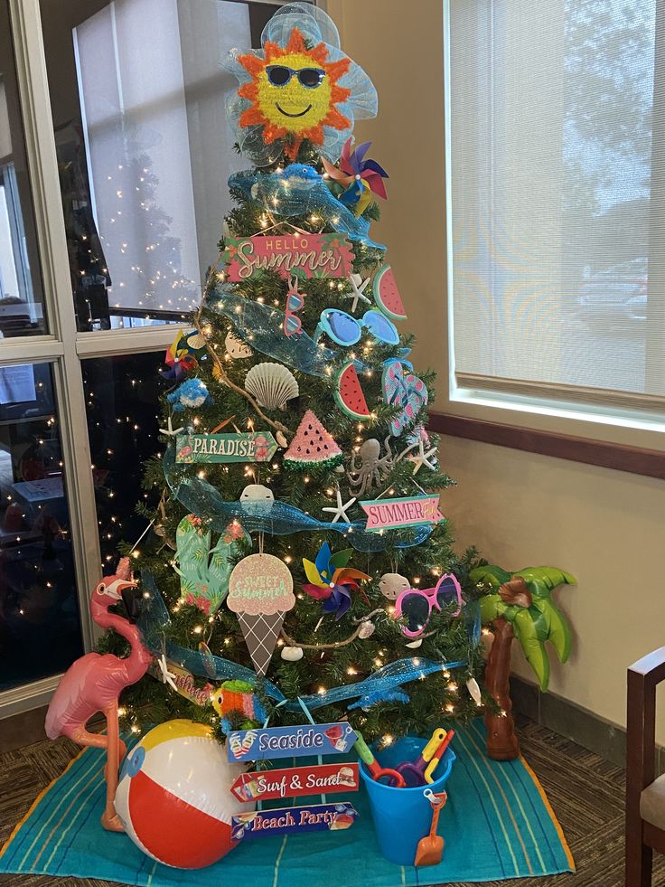 a decorated christmas tree in the corner of a room with toys and decorations on it