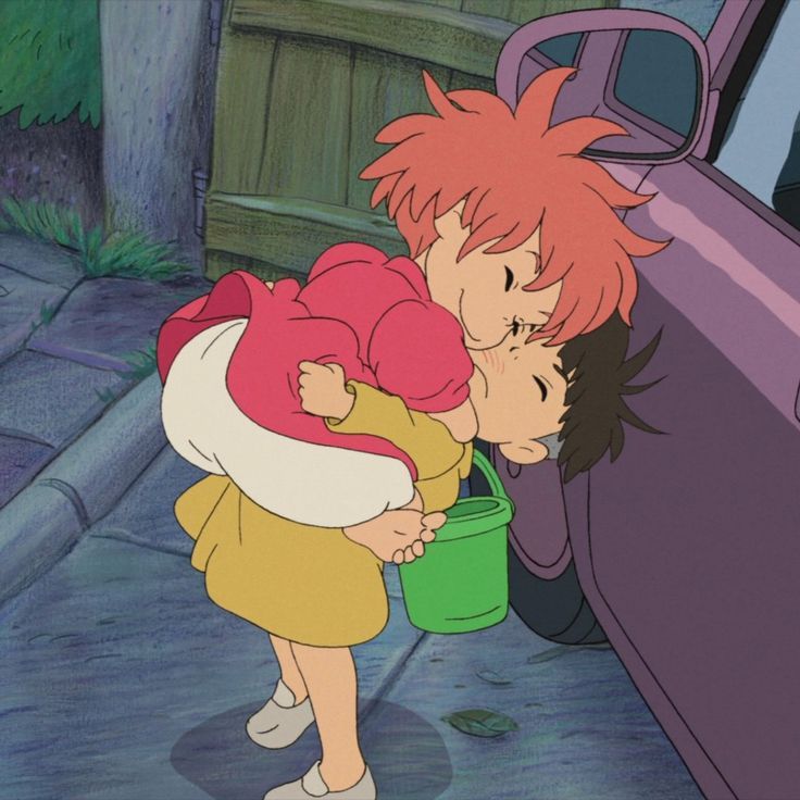 two children kissing each other in front of a car