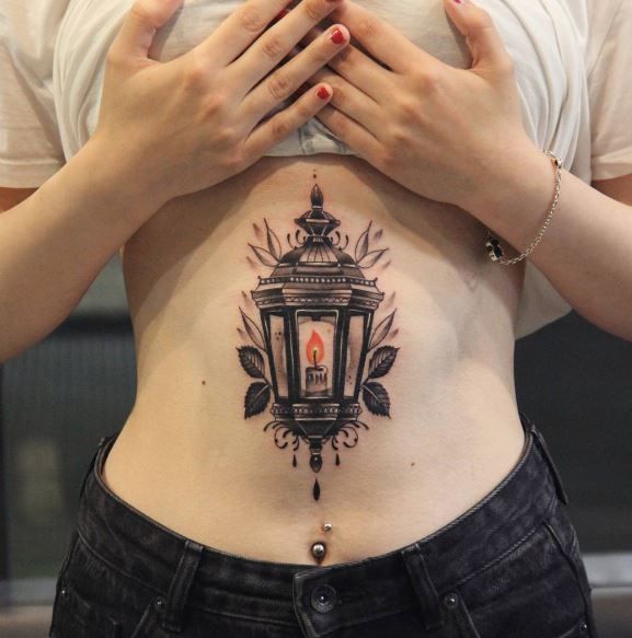 a woman's stomach with tattoos on it and the bottom part of her stomach