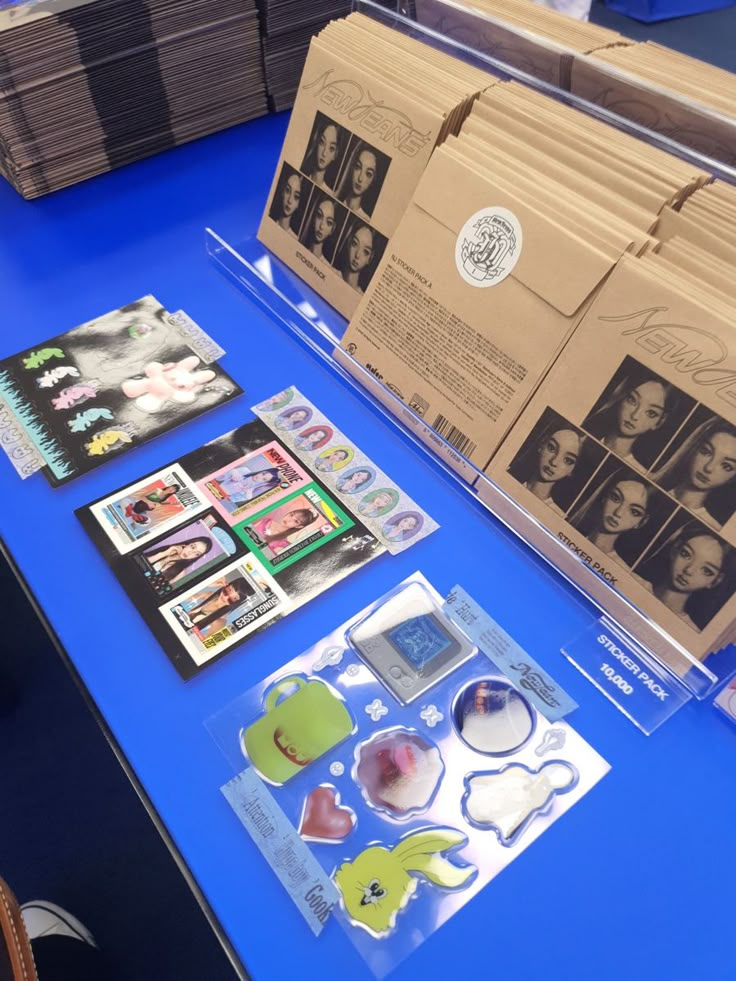 the table is covered with many different items and papers on it, including envelopes