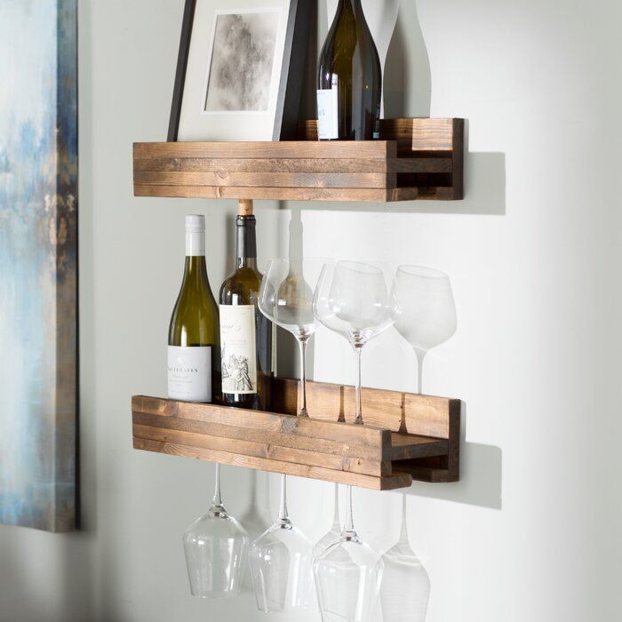 two wooden shelves holding wine glasses and bottles