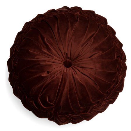 a brown velvet round pillow on a white background