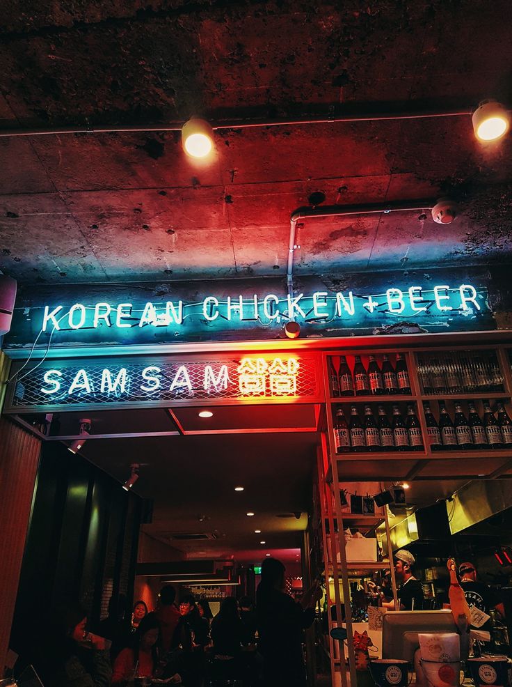 a neon sign that reads korean chicken and beer sam's am blvd