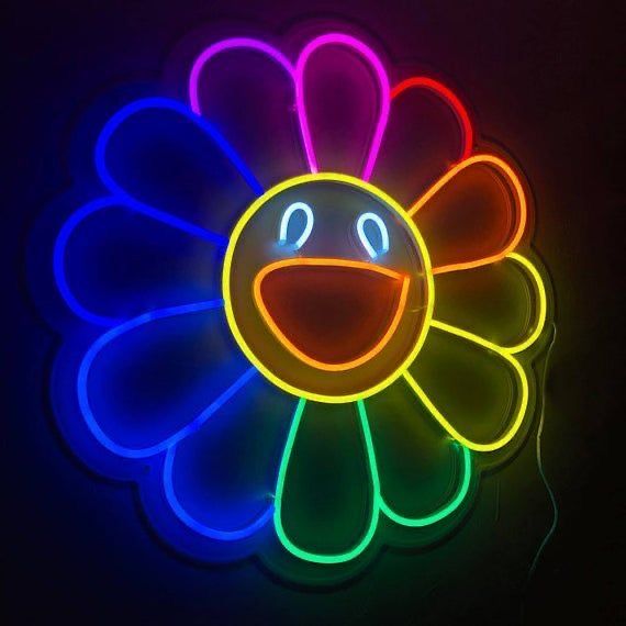 a neon flower with a smiley face on it's backlit side, against a black background