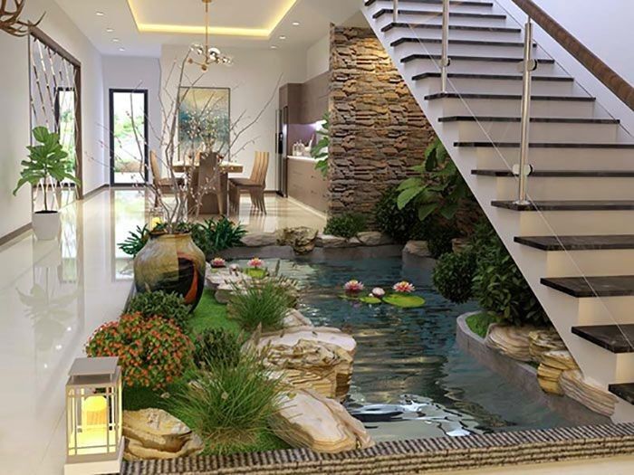 a house with a fish pond in the center and stairs leading up to the second floor