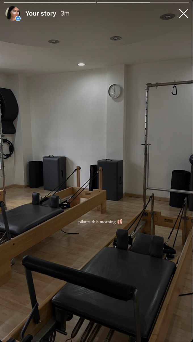 an empty room with black chairs and speakers