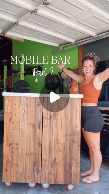 a woman standing behind a wooden bar with the words mobile bar part 2 on it