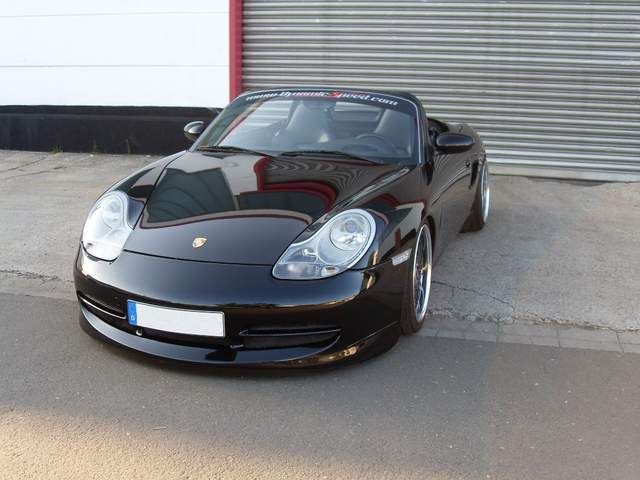 a black sports car parked in front of a garage