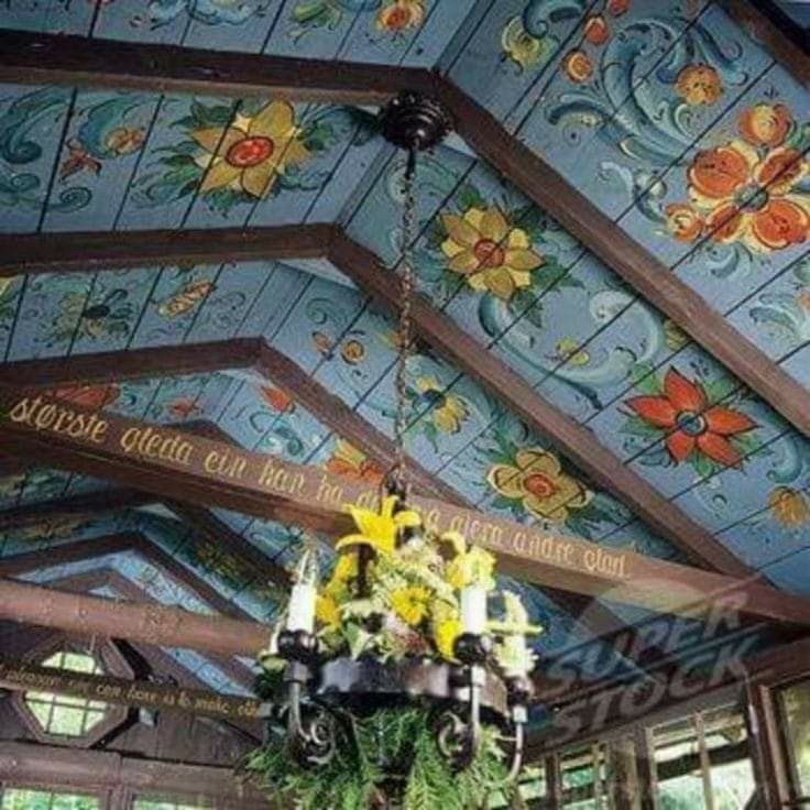 a chandelier hanging from the ceiling in a room with painted walls and ceilings