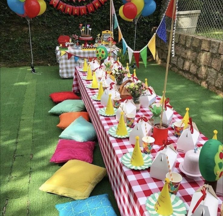 a long table covered in lots of colorful party hats and napkins on top of it