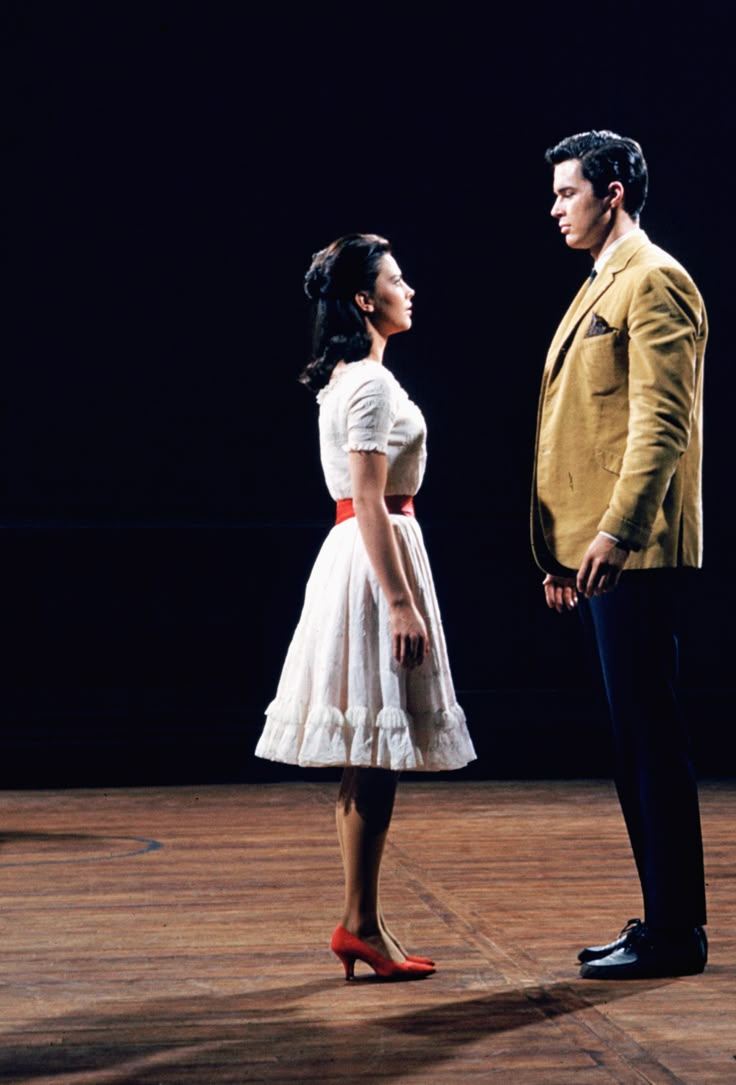 a man and woman standing next to each other on a stage