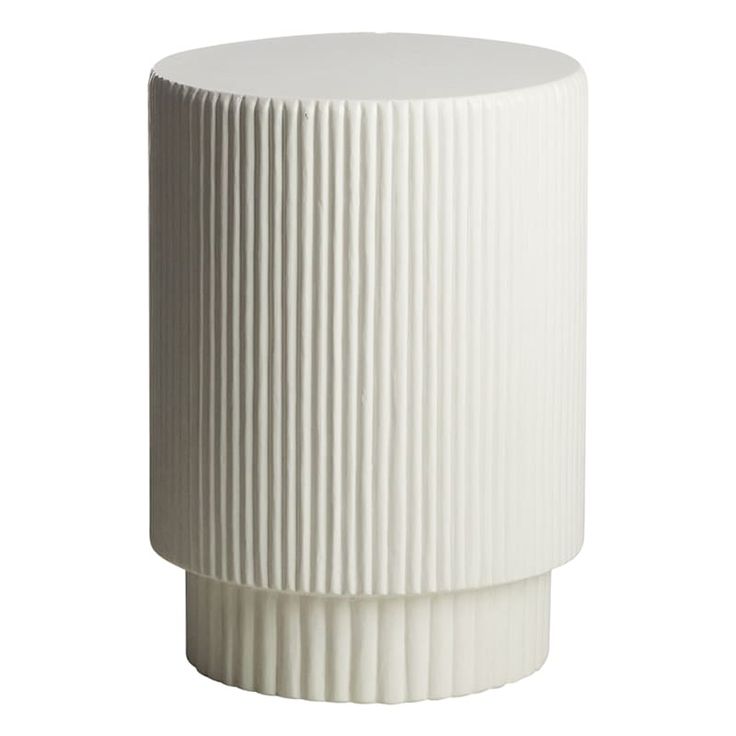 a white vase sitting on top of a table