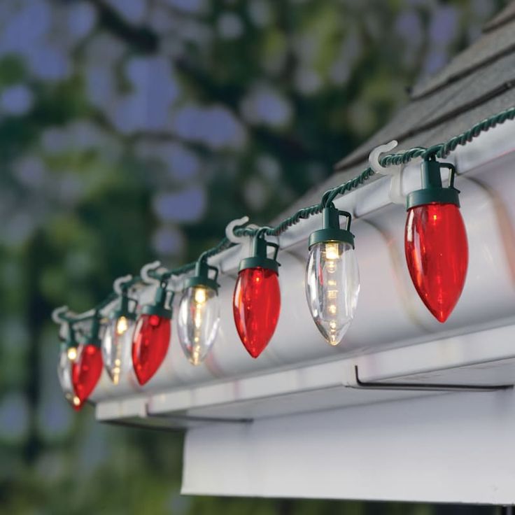 christmas lights are hanging on the side of a house's gutter and gutter