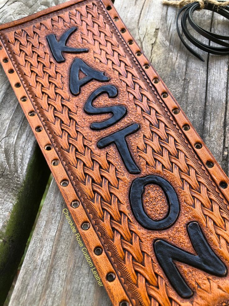 a leather sign that says hot on the inside of it, sitting on a wooden surface