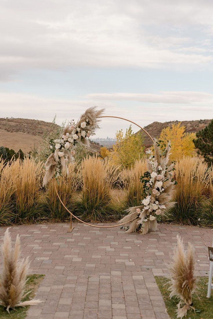 an outdoor wedding ceremony setup with flowers and pamodia