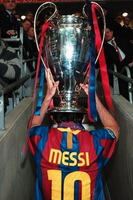 the messi trophy is being held up by a man in red and blue jersey