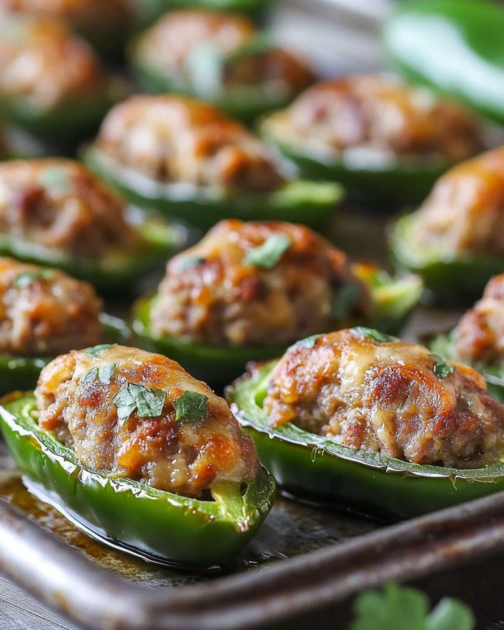 stuffed green peppers with meatballs on them