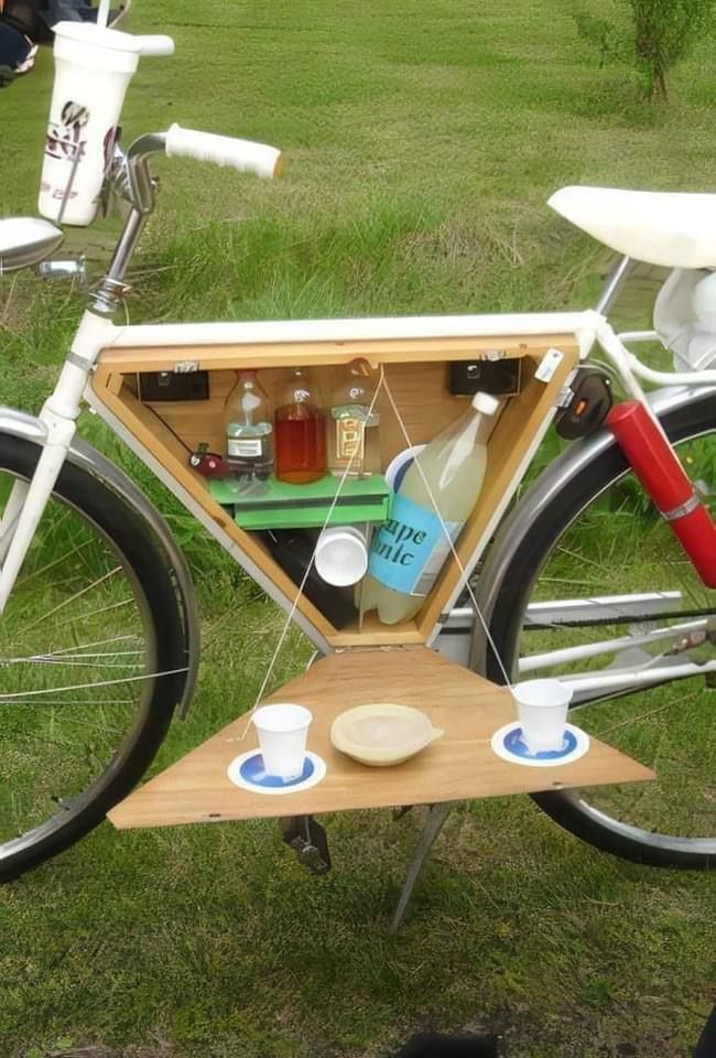 a bicycle with a wooden box on the back and two cups in it's seat