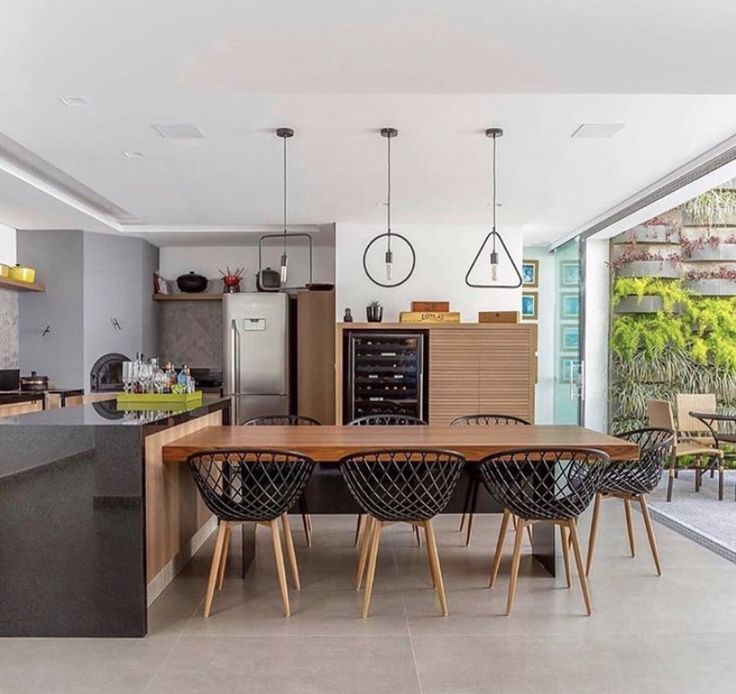 an open kitchen and dining area with modern furniture