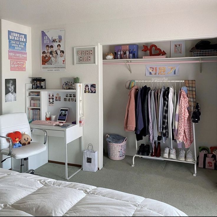 a white bed sitting next to a closet filled with clothes and other items on top of shelves