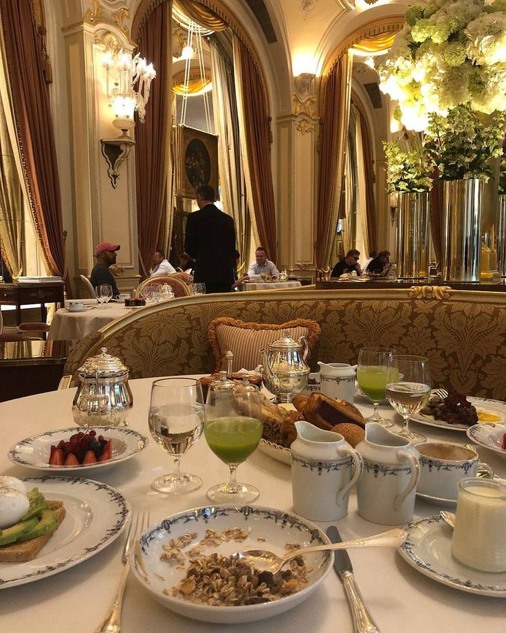 the table is set with many plates and cups on it, along with silverware