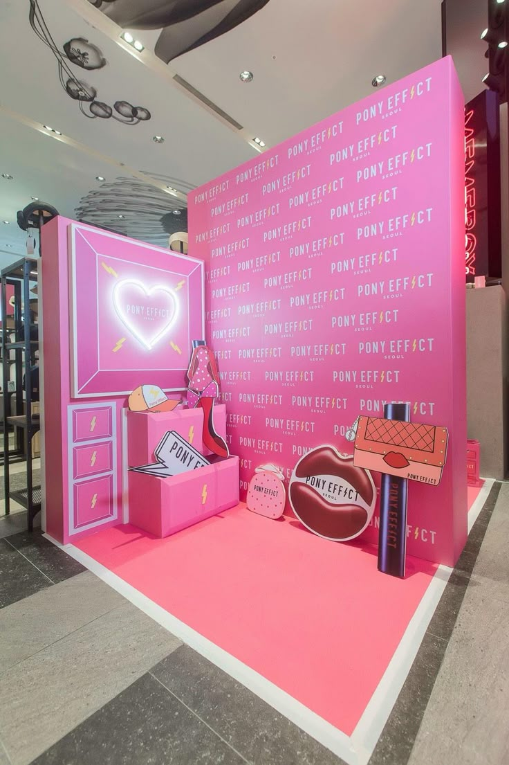 a pink display with lots of items on it