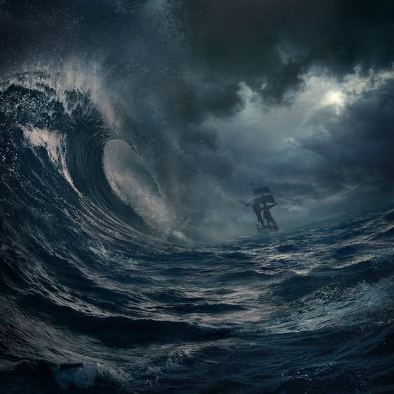 a man standing on top of a wave in the middle of the ocean under a cloudy sky