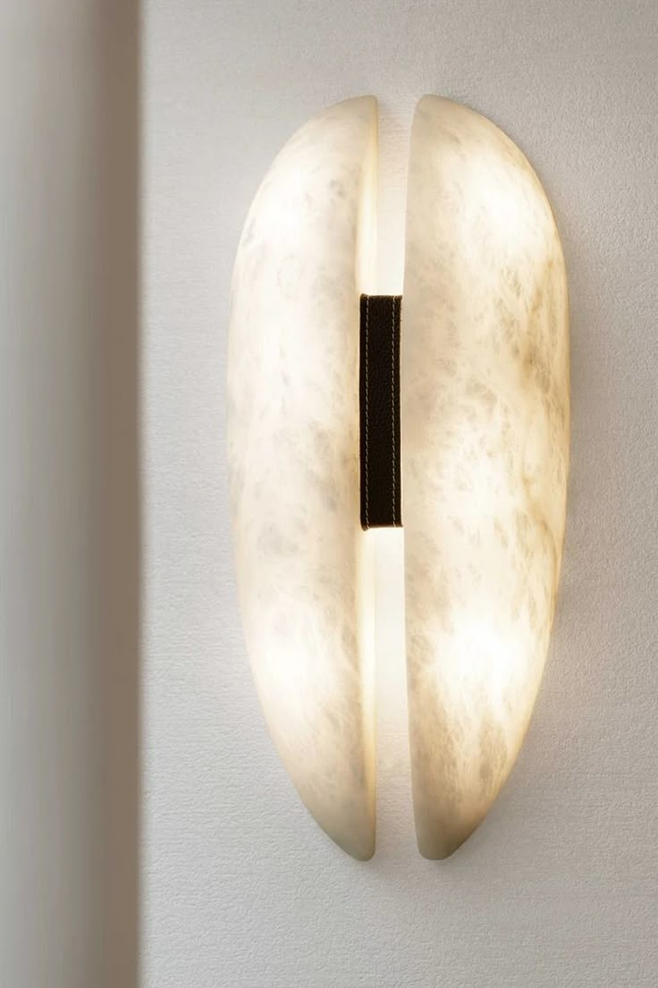 a light that is on the side of a wall with an object in front of it