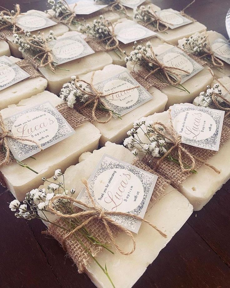 several soap bars wrapped in twine and tied with burlap, some have flowers on them