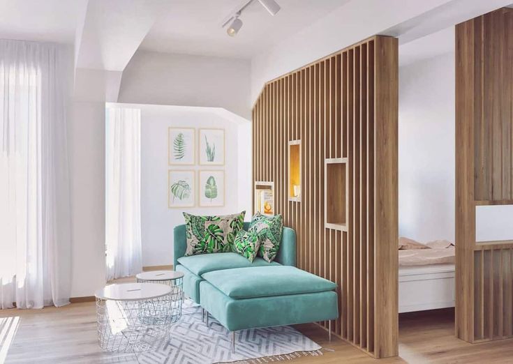 a living room with white walls and wood paneling on the wall, along with a blue couch