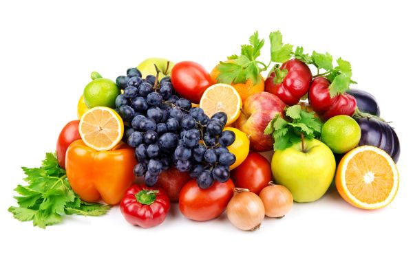 an arrangement of fruits and vegetables on a wooden table with forks, knife and fork