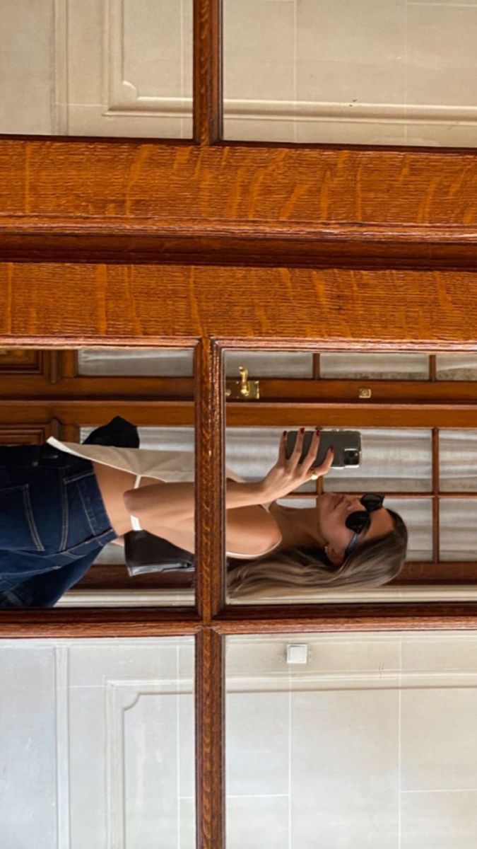 a woman is taking a selfie in the mirror