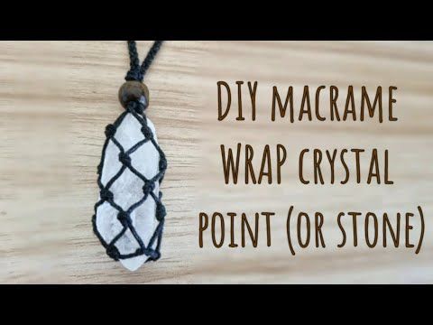 a white and black beaded necklace hanging on a wooden board with the words diy macrame wrap crystal point or stone