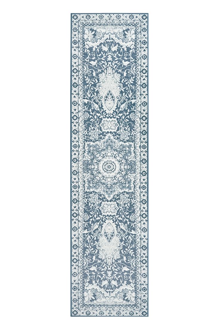 a blue and white runner rug with an ornate design