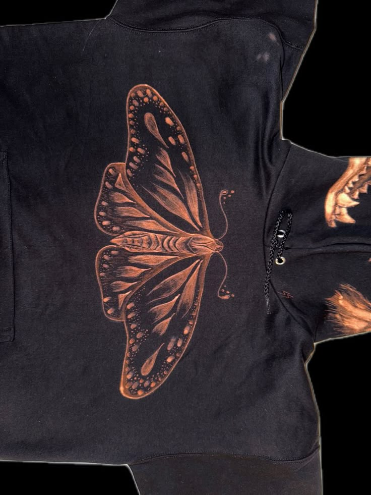 a black jacket with an orange butterfly on it