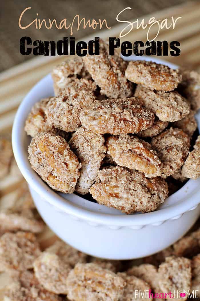 cinnamon sugar candied pecans in a white bowl on a wooden table with text overlay