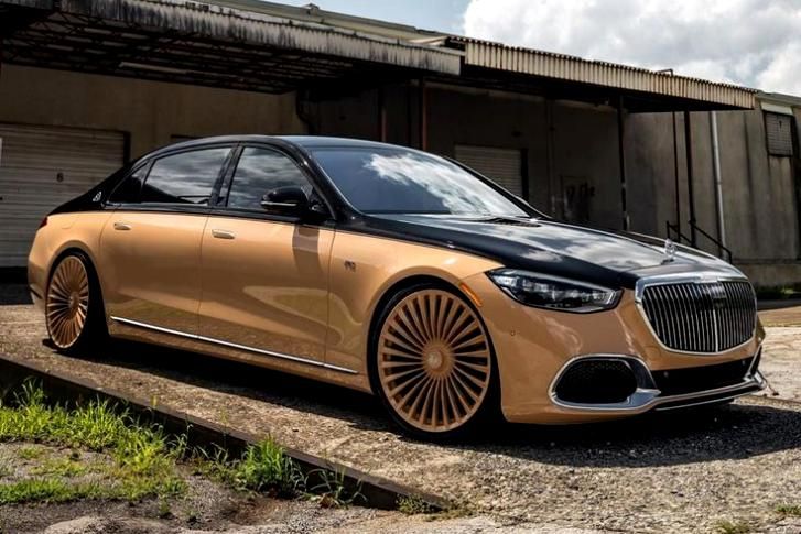 a car parked in front of a building with its wheels on it's rims