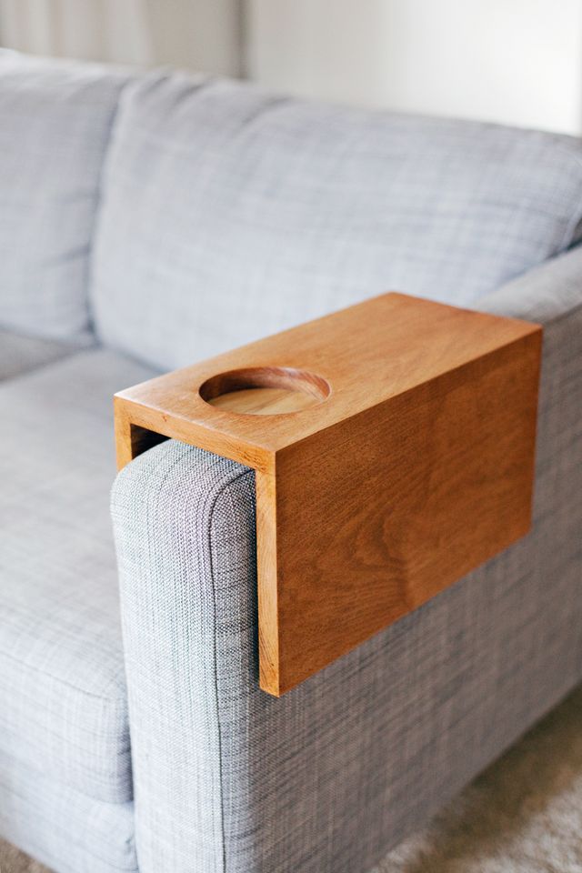 a gray couch with a wooden tray on it