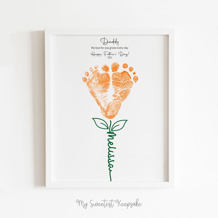 an orange handprinted flower with the words daddy written in green ink on it