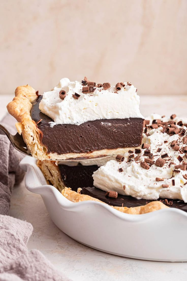 a pie with chocolate and whipped cream on top